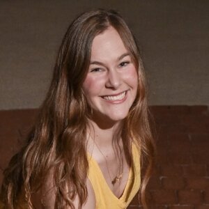 Isabella Russo smiling headshot wearing a yellow shirt