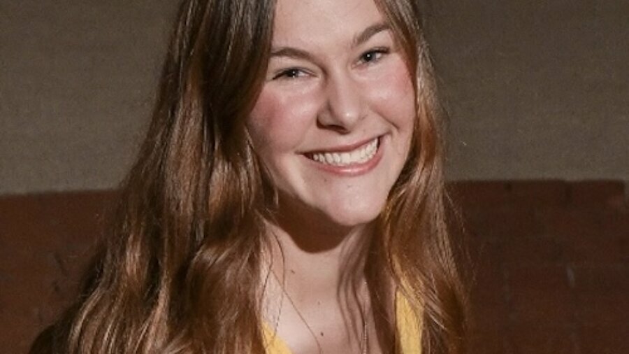 Isabella Russo smiling headshot wearing a yellow shirt