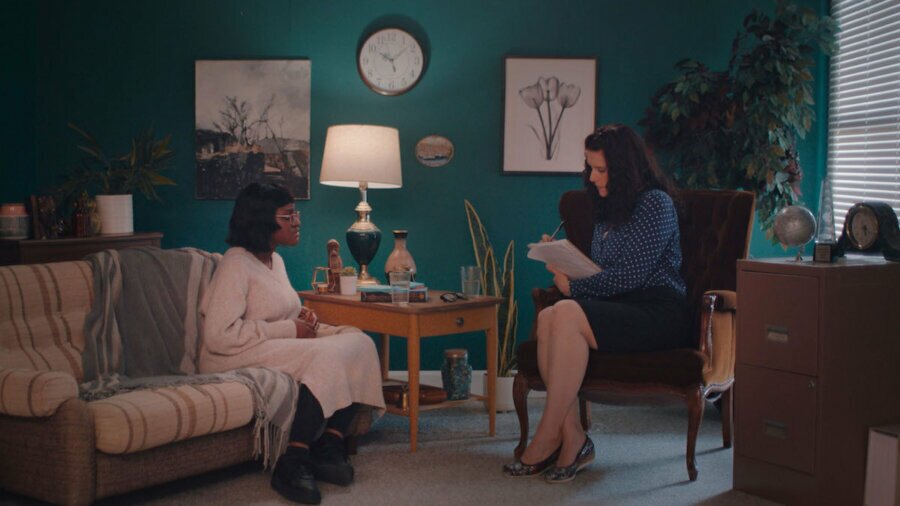 Kitoko Mai and Morgan Bargent sitting in an office having a conversation in a scene from Thriving