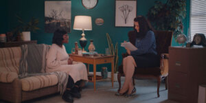 Kitoko Mai and Morgan Bargent sitting in an office having a conversation in a scene from Thriving