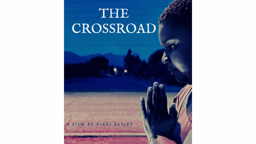 Poster for The Crossroad, a film by Nikki Bailey, with a black woman holding her hands together like she's praying.