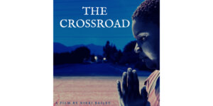 Poster for The Crossroad, a film by Nikki Bailey, with a black woman holding her hands together like she's praying.