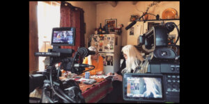 Faith Strongheart looking through a notebook with another woman in a behind-the-scenes still from her documentary