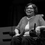 Black and white photo of Judy Heumann giving a TED talk