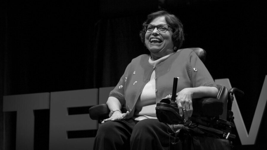 Black and white photo of Judy Heumann giving a TED talk