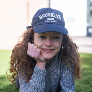 Annie Hayes headshot wearing a blue baseball cap