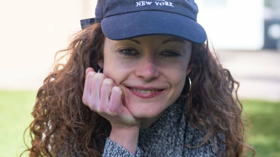 Annie Hayes headshot wearing a blue baseball cap