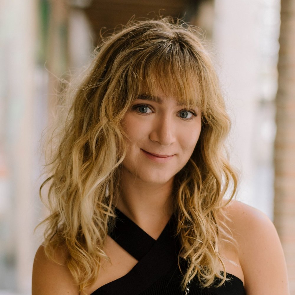 Catherine Argyrople smiling headshot wearing a black dress