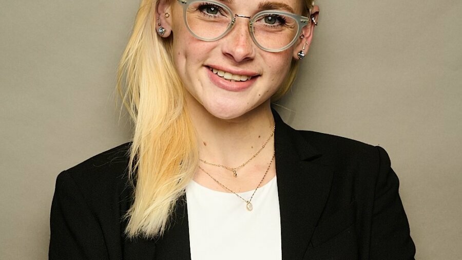 Chrissy Marshall smiling headshot wearing a black blazer and a white shirt