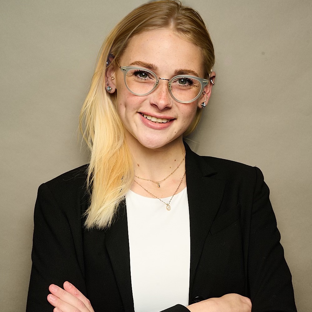 Chrissy Marshall smiling headshot wearing a black blazer and a white shirt