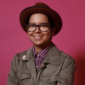 Lorena Gordon headshot wearing a hat and a grey jacket