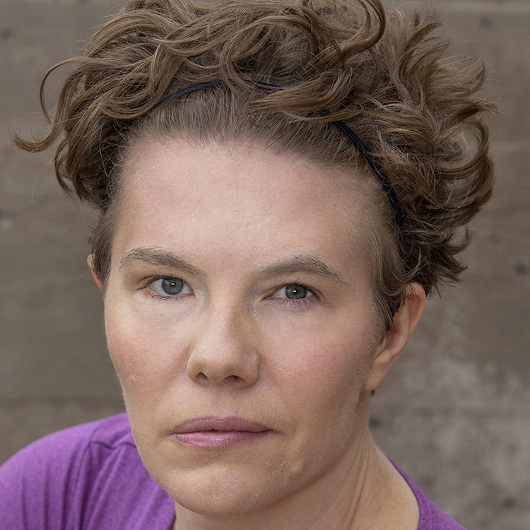 Maggie Whittum headshot wearing a purple shirt