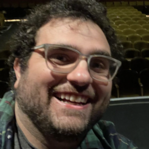 Rick Cisario headshot in front of an empty theater