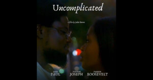 poster for "Uncomplicated" by Juliet Romeo featuring the two lead actors looking at each other in a dark environment