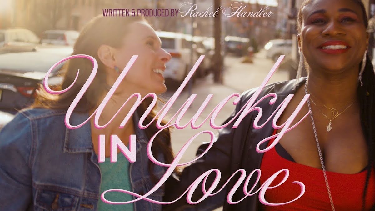 Key art for Unlucky In Love featuring Rachel Handler and Lachi holding hands walking down a city sidewalk.