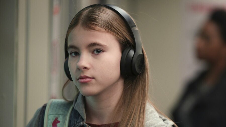 Shaylee Mansfield wearing headphones in a scene from a new episode of 