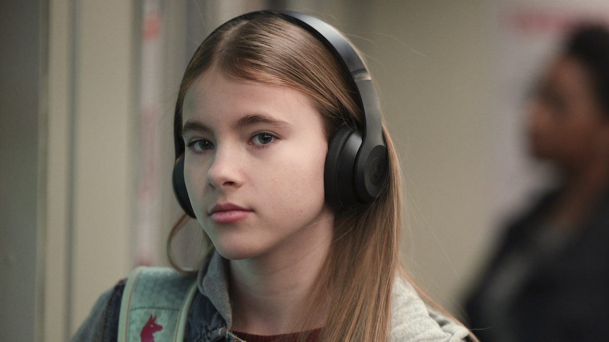 Shaylee Mansfield wearing headphones in a scene from a new episode of "The Company You Keep"