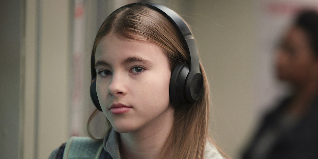 Shaylee Mansfield wearing headphones in a scene from a new episode of "The Company You Keep"
