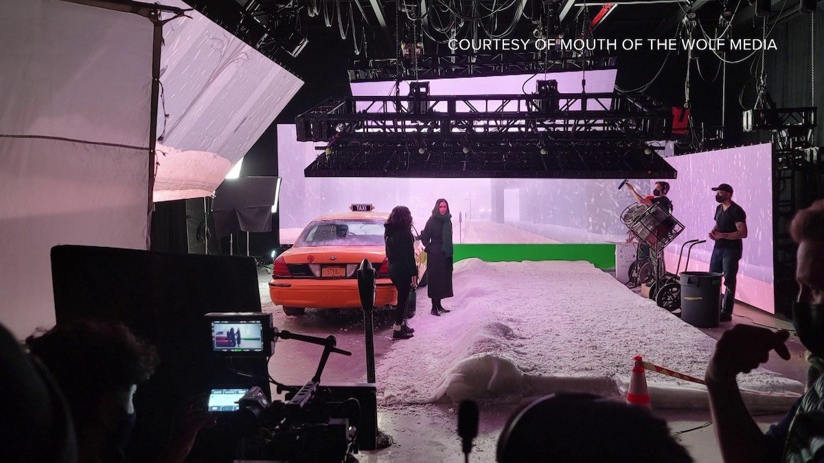 Behind-the-scenes still from "The Cab" production with a taxi cab and a large pile of sand.