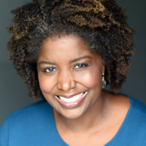 Francine Daniels smiling headshot wearing a blue shirt