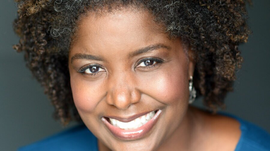 Francine Daniels smiling headshot wearing a blue shirt