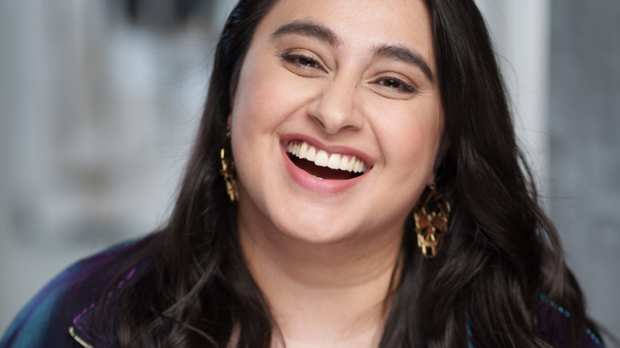 Rabiya Mansoor headshot laughing with a blurred background