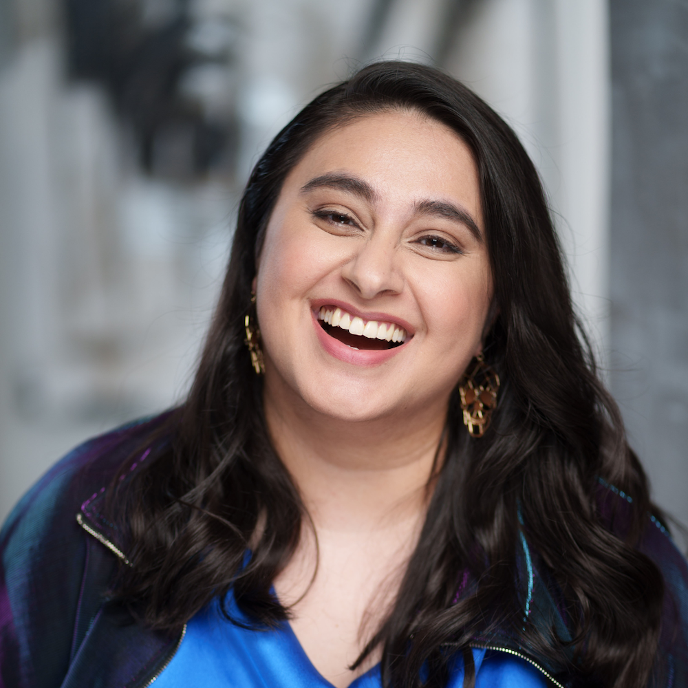 Rabiya Mansoor headshot laughing with a blurred background