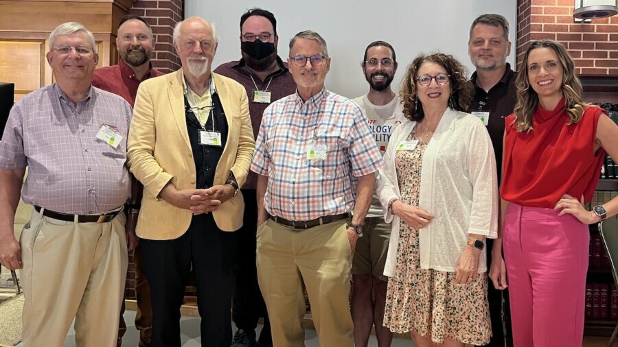 nine attendees at the Institute on Theology and Disability smile together