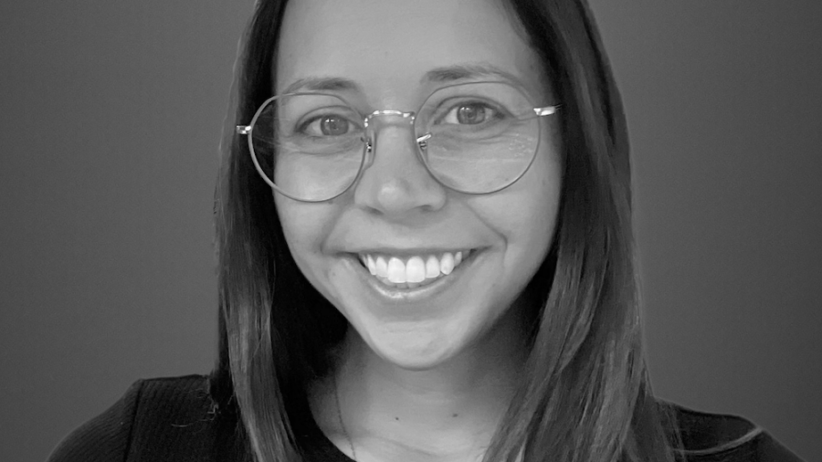 Lydia Moro smiling headshot wearing glasses and a black shirt