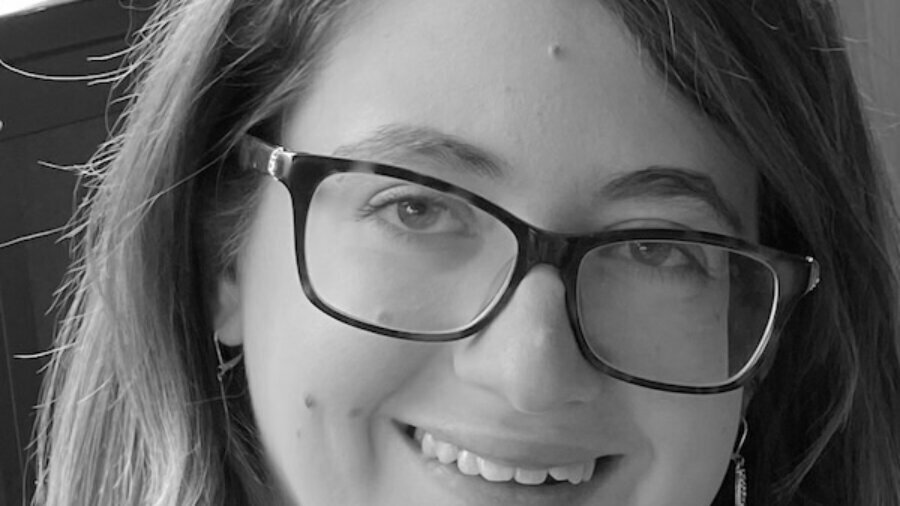 Melissa Tessaro smiling headshot wearing glasses