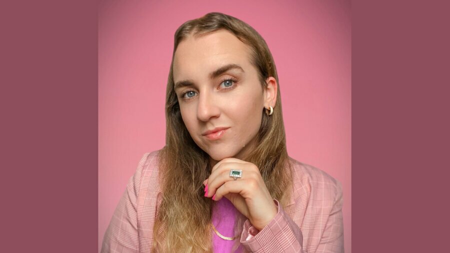 Julian Gavino smiling headshot wearing a pink patterned blazer