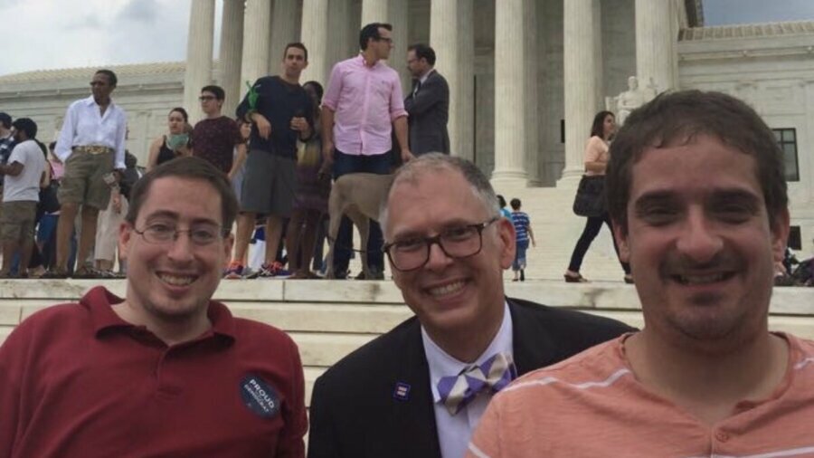 Jim Obergefell with Ben Spangenberg and Justin Chappell in front of the Supreme Court steps smiling together