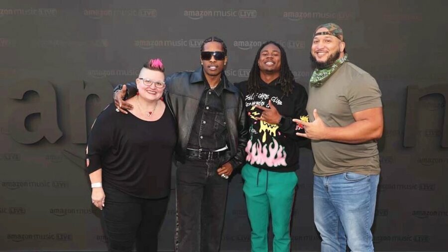 Four ASL interpreters at the Amazon Music Live concert series smile together