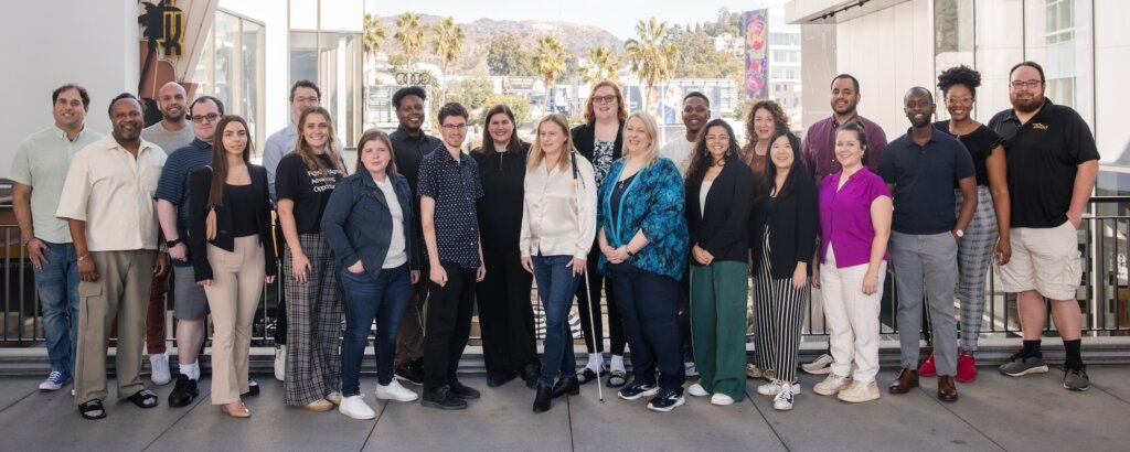 RespectAbility Staff smiling together with the Hollywood sign in the distant background