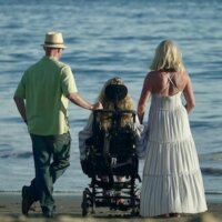 still from Amazing Grace with three characters looking at the ocean including one using a wheelchair