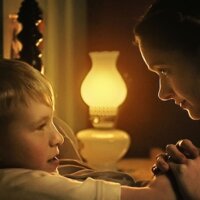 Still from Forgive Us Our Trespasses with a mom and song holding hands