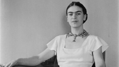 Frida Kahlo black and white photo wearing a white dress from FRIDA