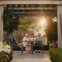 still from MatchMaker with two people sitting outside at a table