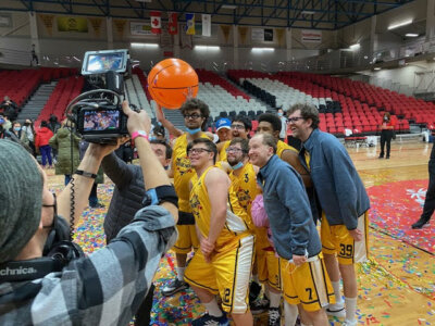 Kevin Iannucci with the cast of Champions on the set with confetti on the ground and a basketball in the air