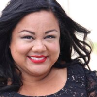 Jennifer Kumiyama smiling headshot wearing a black dress