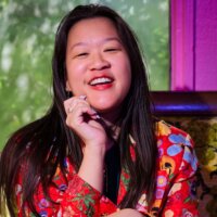 Maddy Ullman smiling headshot wearing a colorful shirt