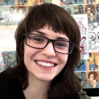 Chloe Moon smiling headshot in front of a wall of artwork