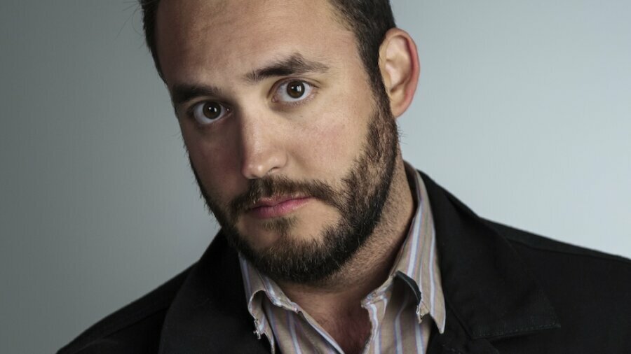 Christopher Guerrero headshot wearing a blazer