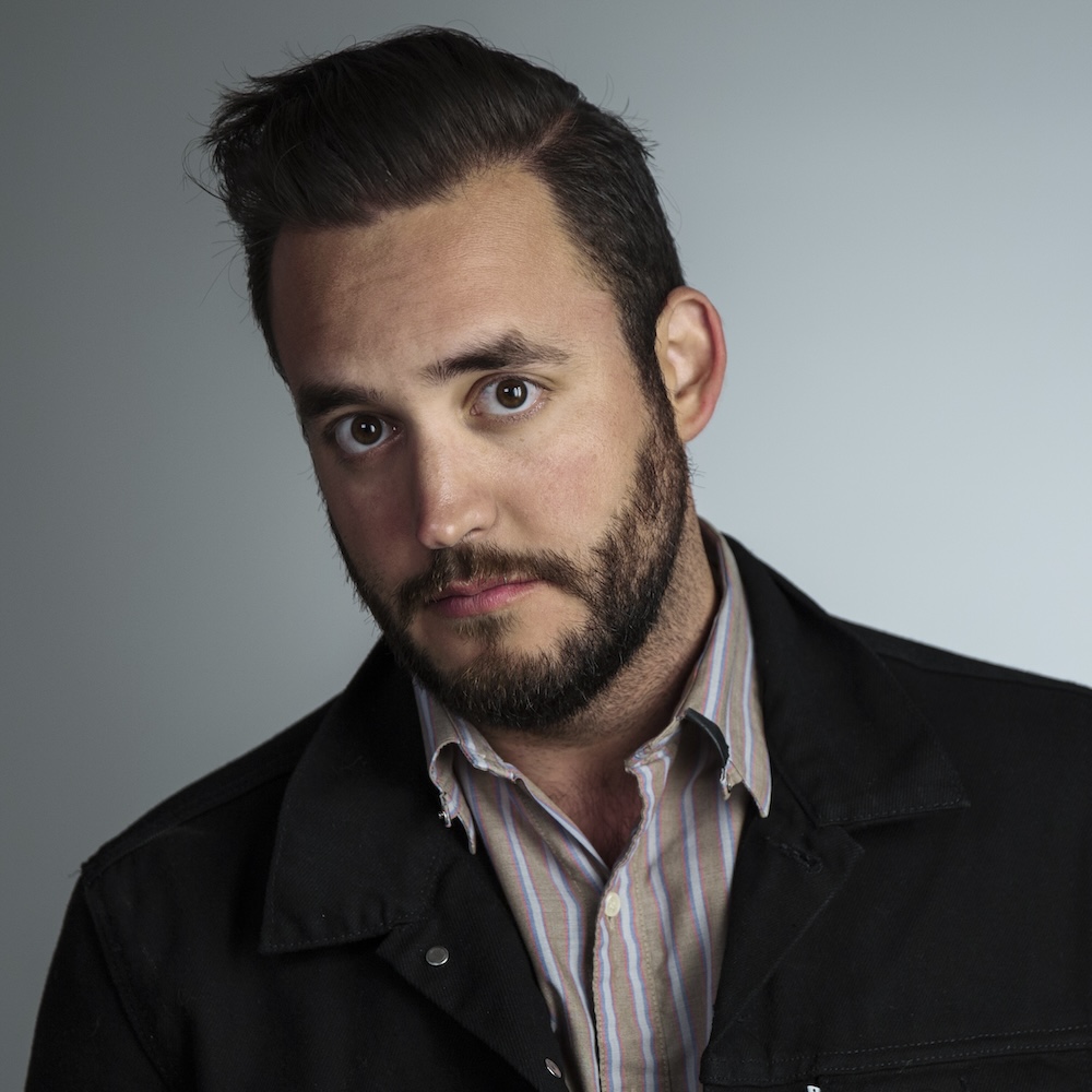 Christopher Guerrero headshot wearing a blazer