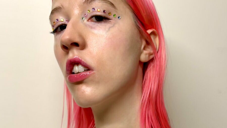 Emma Layden smiling headshot with glitter around her eyes