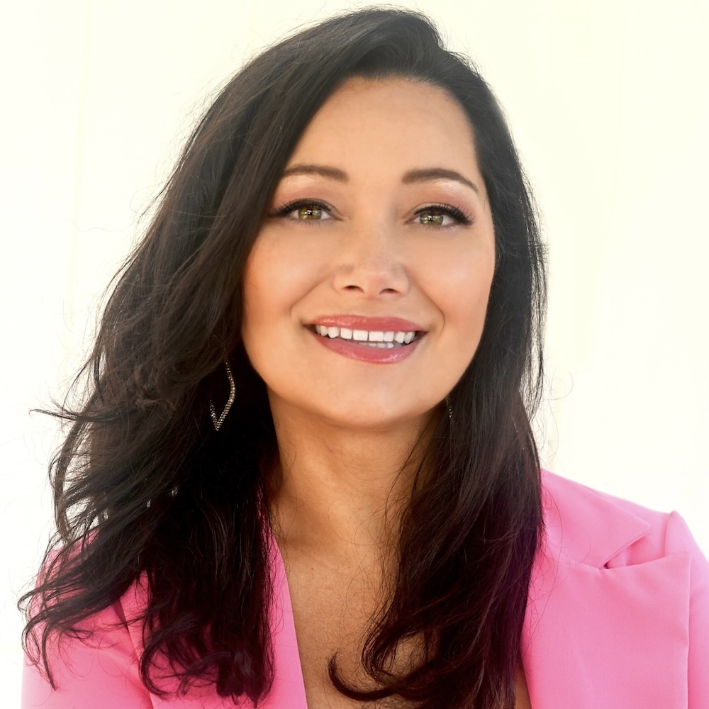 Genevieve McDevitt smiling headshot wearing a pink blazer