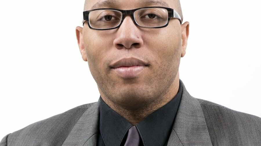Stephan Collins-Stepney headshot wearing a suit and tie