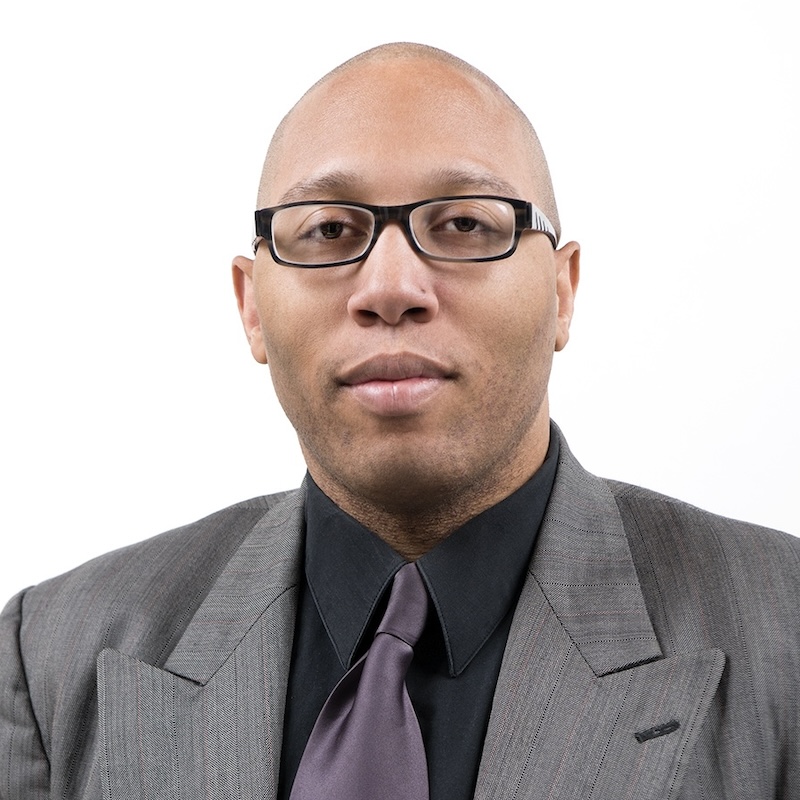 Stephan Collins-Stepney headshot wearing a suit and tie
