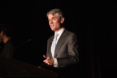 Wells Fargo Chief Accessibility Officer Andrew Holbrook speaking behind a podium at our 10th Anniversary Celebration