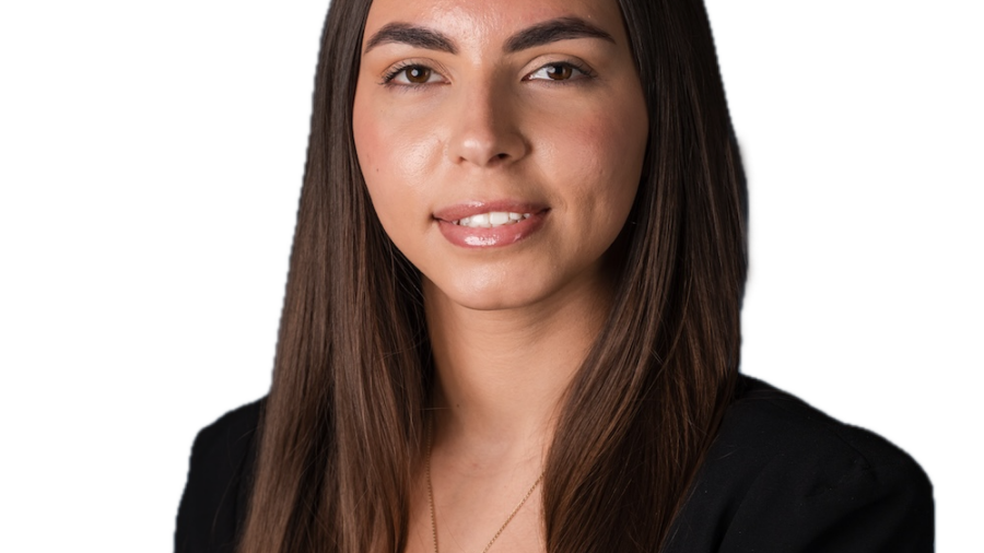 Donjeta Sahiti smiling headshot wearing a black jacket and shirt